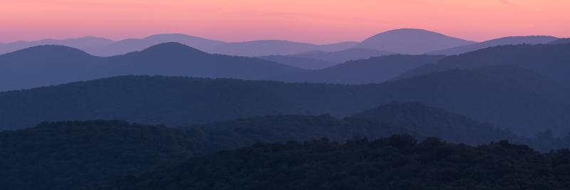 Pastel pink and purple sunrise over cascading mountain ridges in Shenandoah National Park